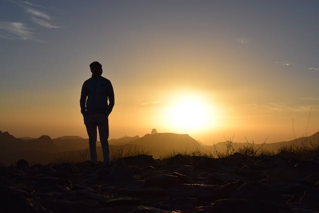 Confident man gazing at the sunset, capturing strength and contemplation in a moment of quiet confidence and self-assurance.